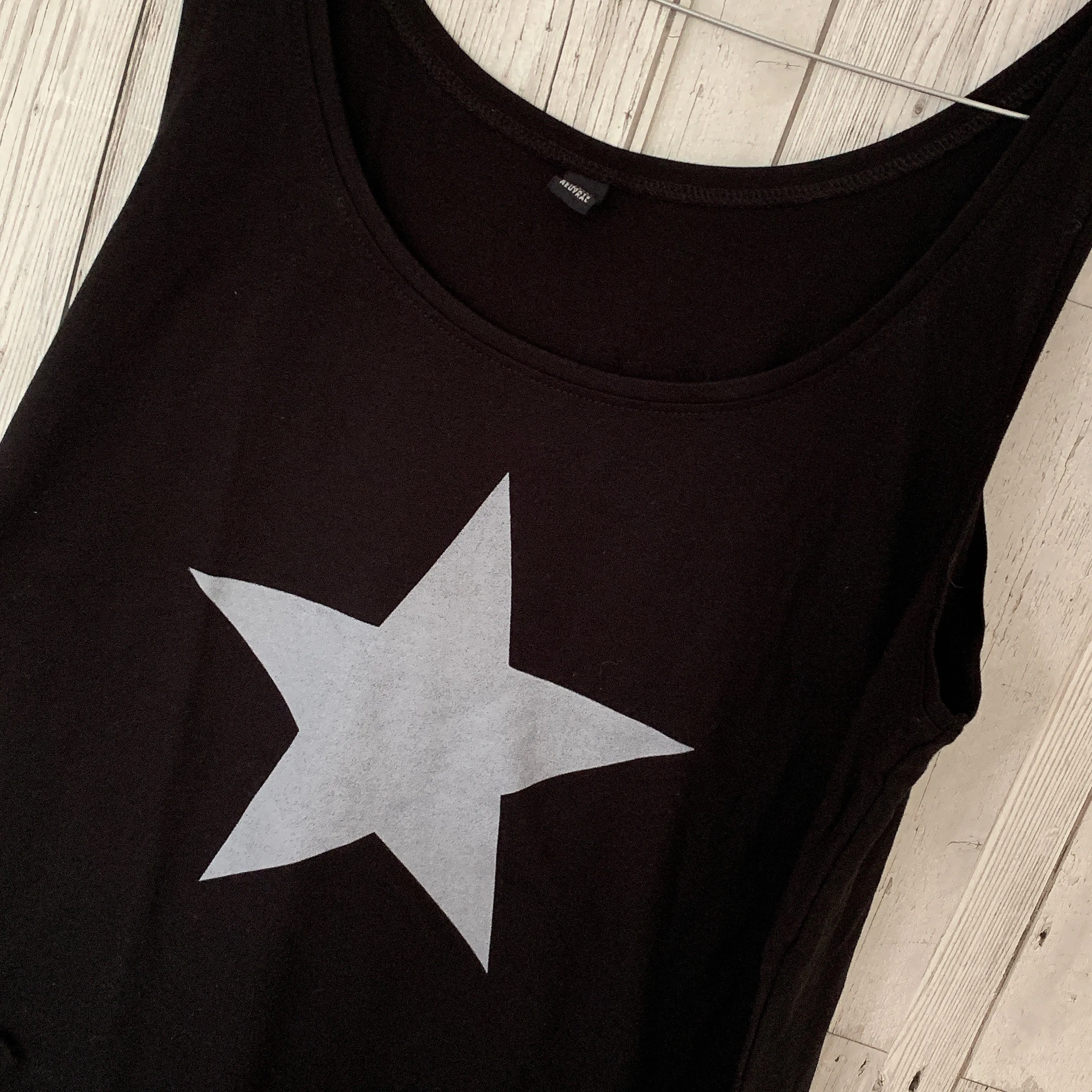 Silvery grey star on black vest top